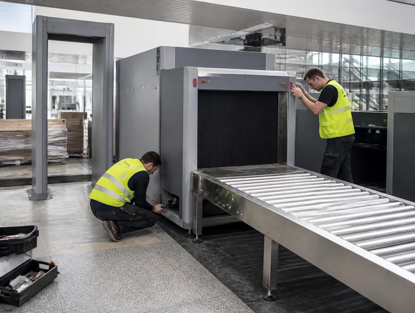 Airport security screening equipment being installed in a terminal